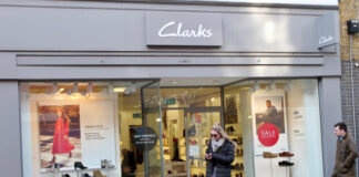 A strike is continuing at the Clarks warehouse in Somerset with workers saying the retailer wants to fire and rehire them.